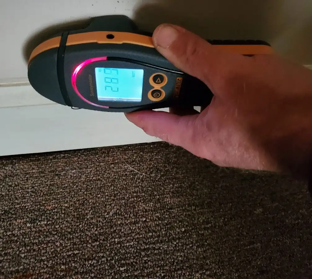 Moisture detection at baseboard during Storm Damage Restoration in Bay Harbor Islands